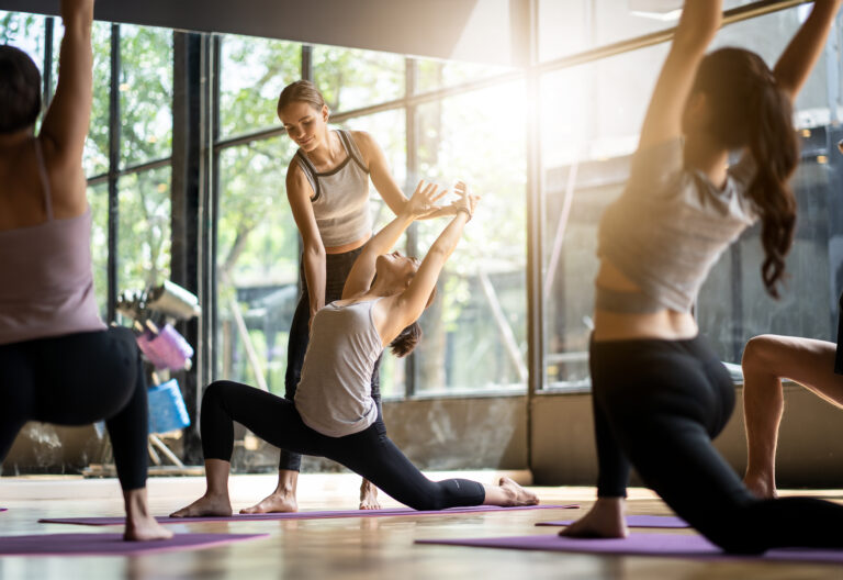 Group of multi ethnics people learning Yoga class in fitness clu