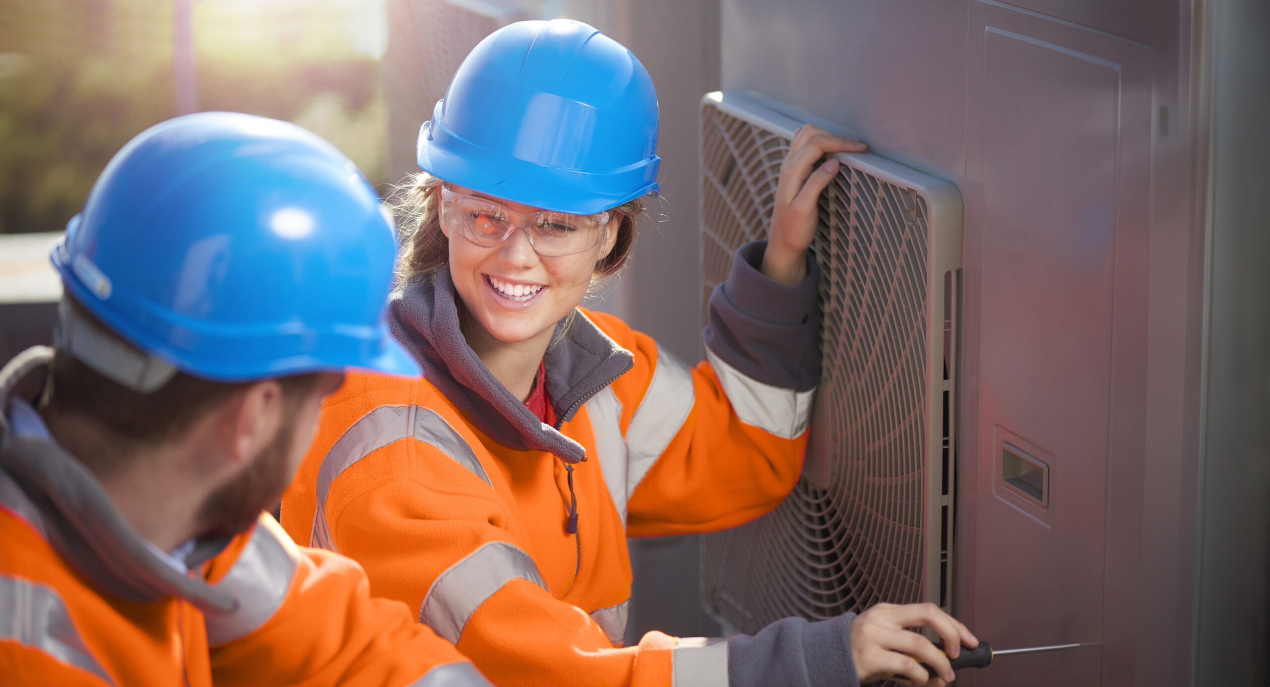 Female air conditioning technician with her supervisor